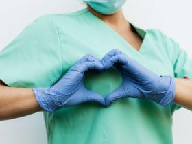 Healthcare Professional Forming a Heart with Gloved Hands
