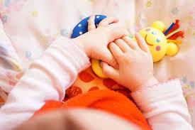 A baby's hand on toys