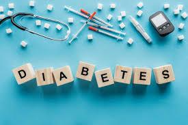 The word diabetes with insulin syringes, a glucose monitor, stethoscope and sugar cubes