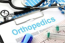 The word orthopedics on a clipboard