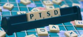 scrabble tiles spelling out PTSD