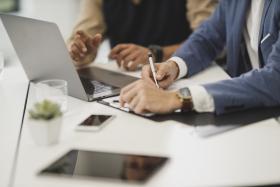 Two People Working Together at a Laptop